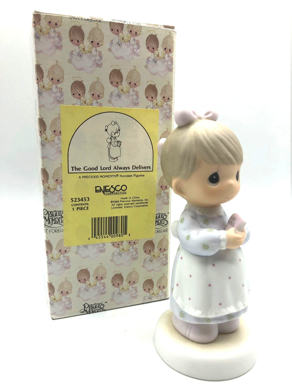 Precious Moments "The Good Lord Always Delivers" Porcelain Figurine. Features a little expectant mom perusing a book of baby names.