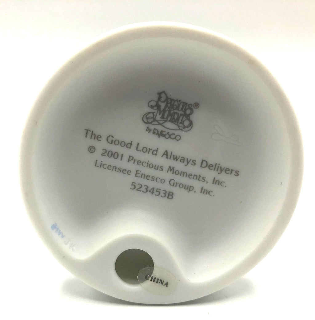 Precious Moments "The Good Lord Always Delivers" Porcelain Figurine. Features a little expectant mom perusing a book of baby names.