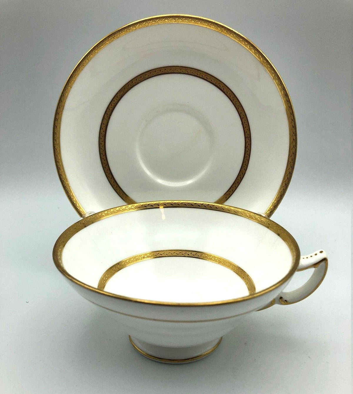 Vintage Mintons of England Footed Tea Cup and Saucer with Brilliant Gold Detail and Trim by Sim & Co. Troy NY.  Elegant and beautiful.