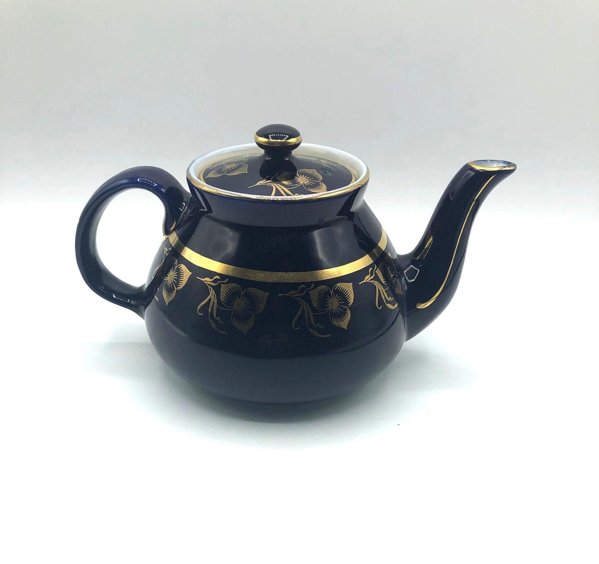 Vintage Hall's Cobalt Blue Teapot with Gold Flower Pattern and Gold Trim.  8.5" Spout to Handle and 5.5" high with lid.  6 Cup Capacity.