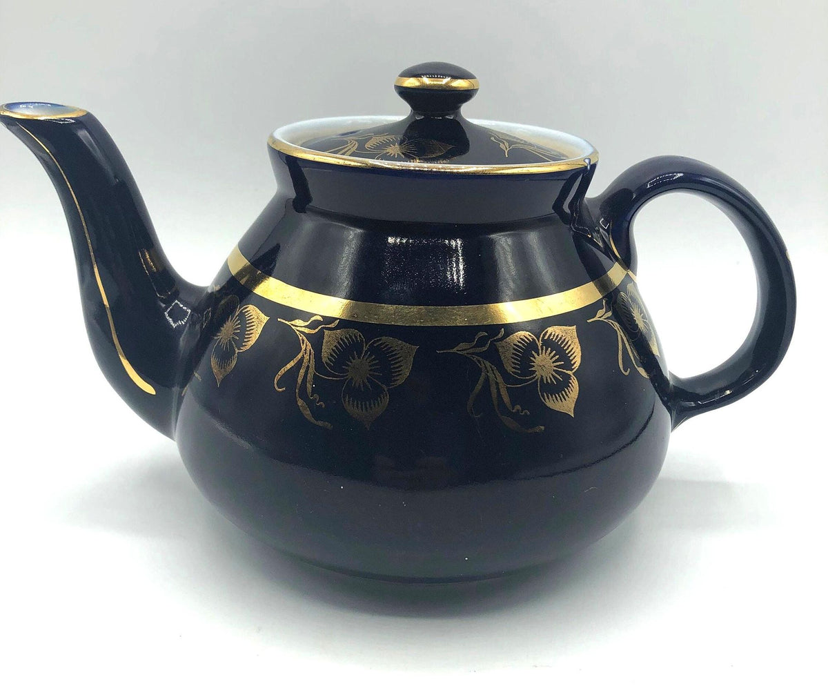 Vintage Hall's Cobalt Blue Teapot with Gold Flower Pattern and Gold Trim.  8.5" Spout to Handle and 5.5" high with lid.  6 Cup Capacity.