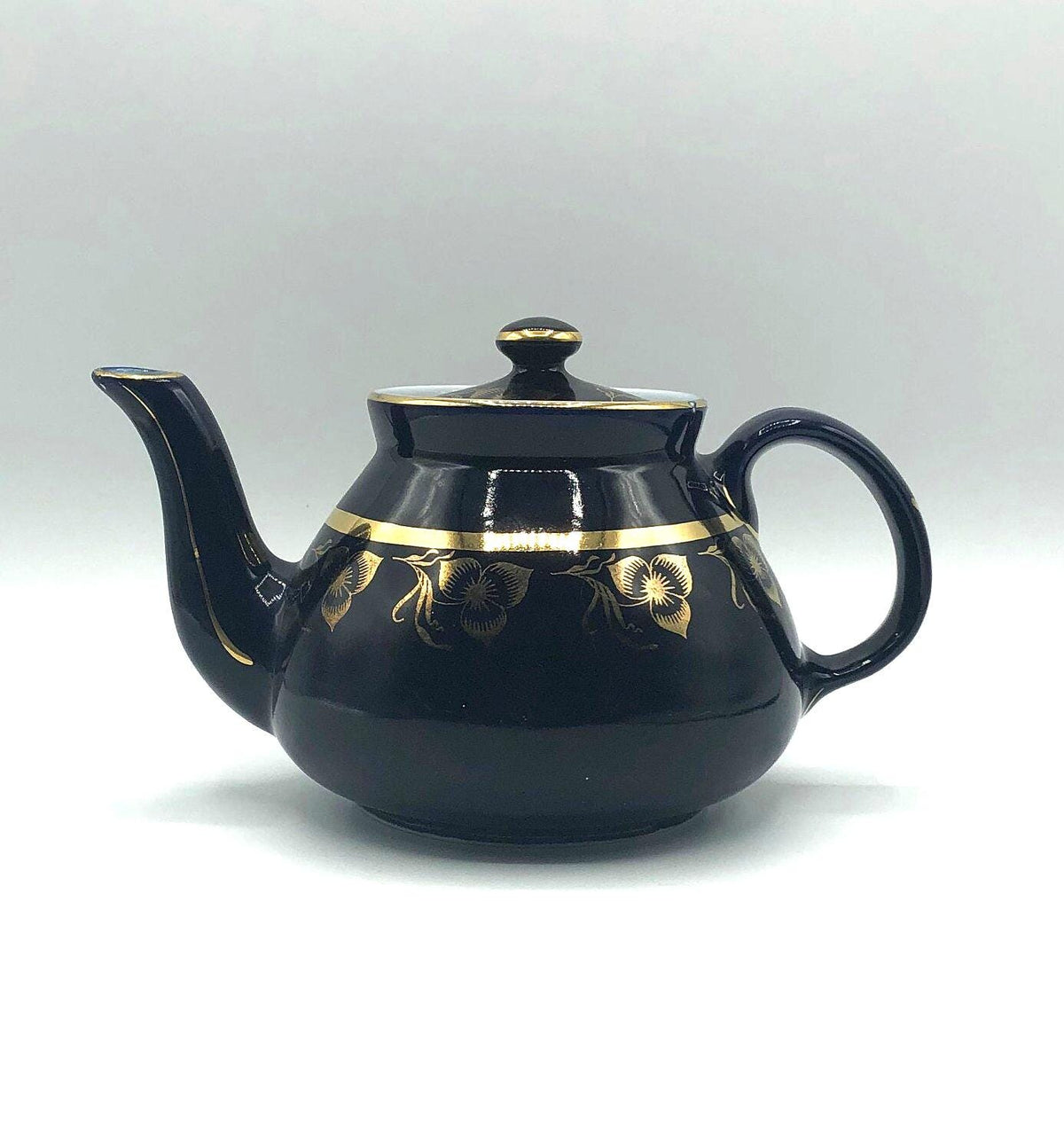 Vintage Hall's Cobalt Blue Teapot with Gold Flower Pattern and Gold Trim.  8.5" Spout to Handle and 5.5" high with lid.  6 Cup Capacity.