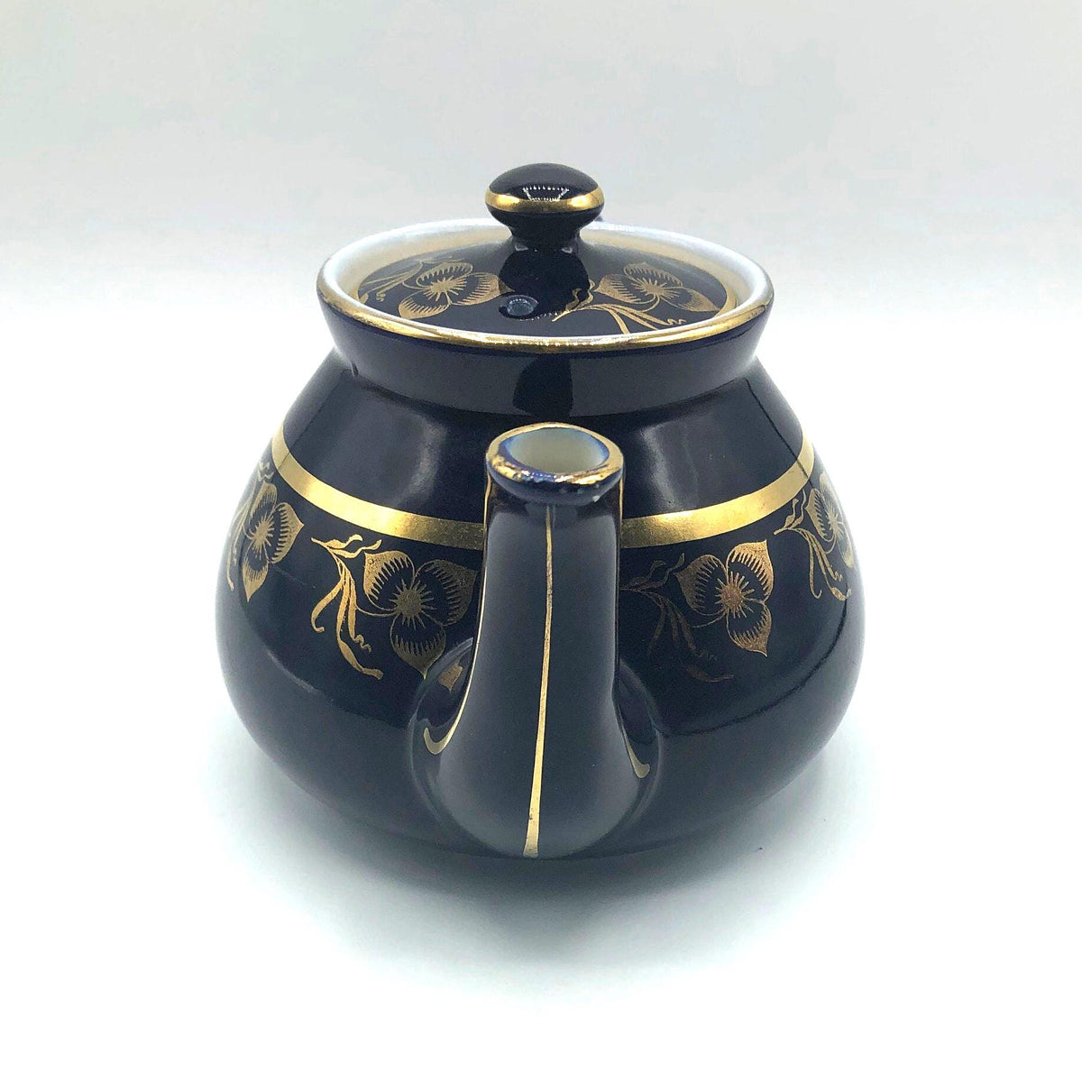 Vintage Hall's Cobalt Blue Teapot with Gold Flower Pattern and Gold Trim.  8.5" Spout to Handle and 5.5" high with lid.  6 Cup Capacity.