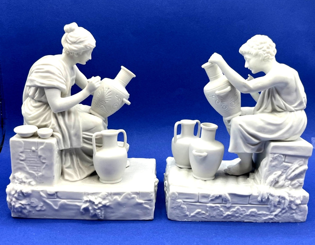 Vintage Neoclassical Greek Roman White Bisque Porcelain Figurines Depicting Male and Female Potters Shaping and Detailing Vases. 8" tall