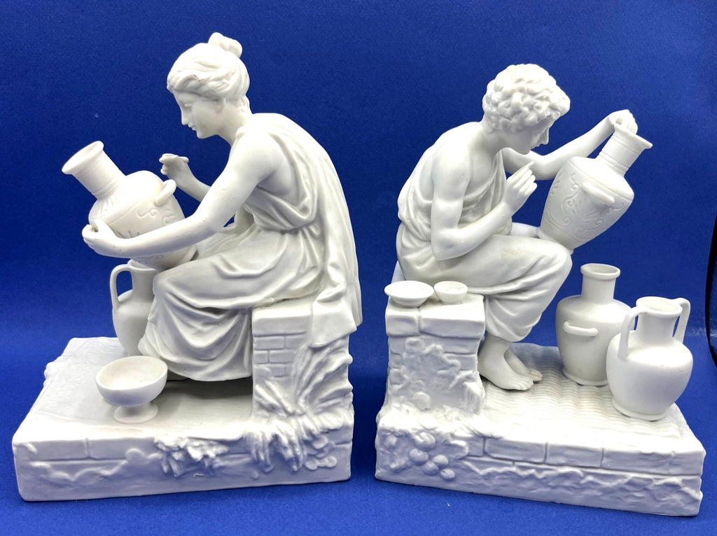 Vintage Neoclassical Greek Roman White Bisque Porcelain Figurines Depicting Male and Female Potters Shaping and Detailing Vases. 8" tall