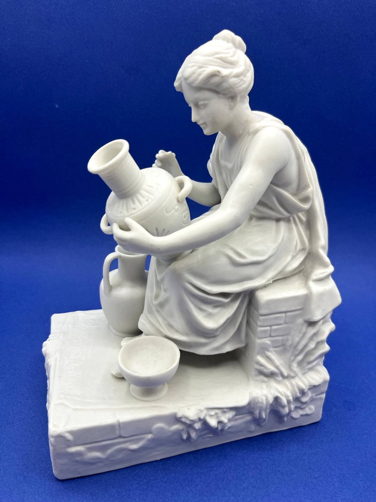 Vintage Neoclassical Greek Roman White Bisque Porcelain Figurines Depicting Male and Female Potters Shaping and Detailing Vases. 8" tall