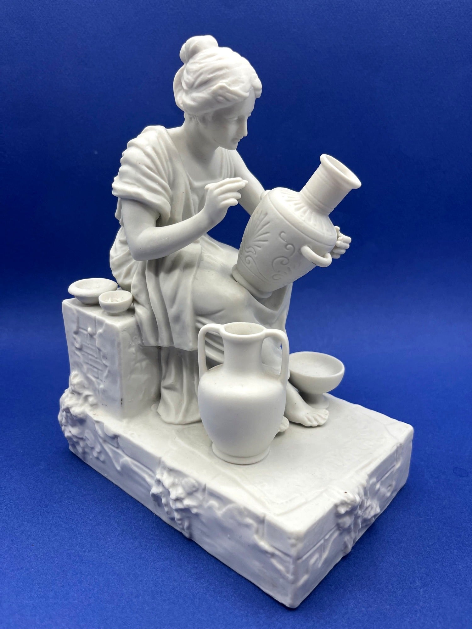 Vintage Neoclassical Greek Roman White Bisque Porcelain Figurines Depicting Male and Female Potters Shaping and Detailing Vases. 8" tall