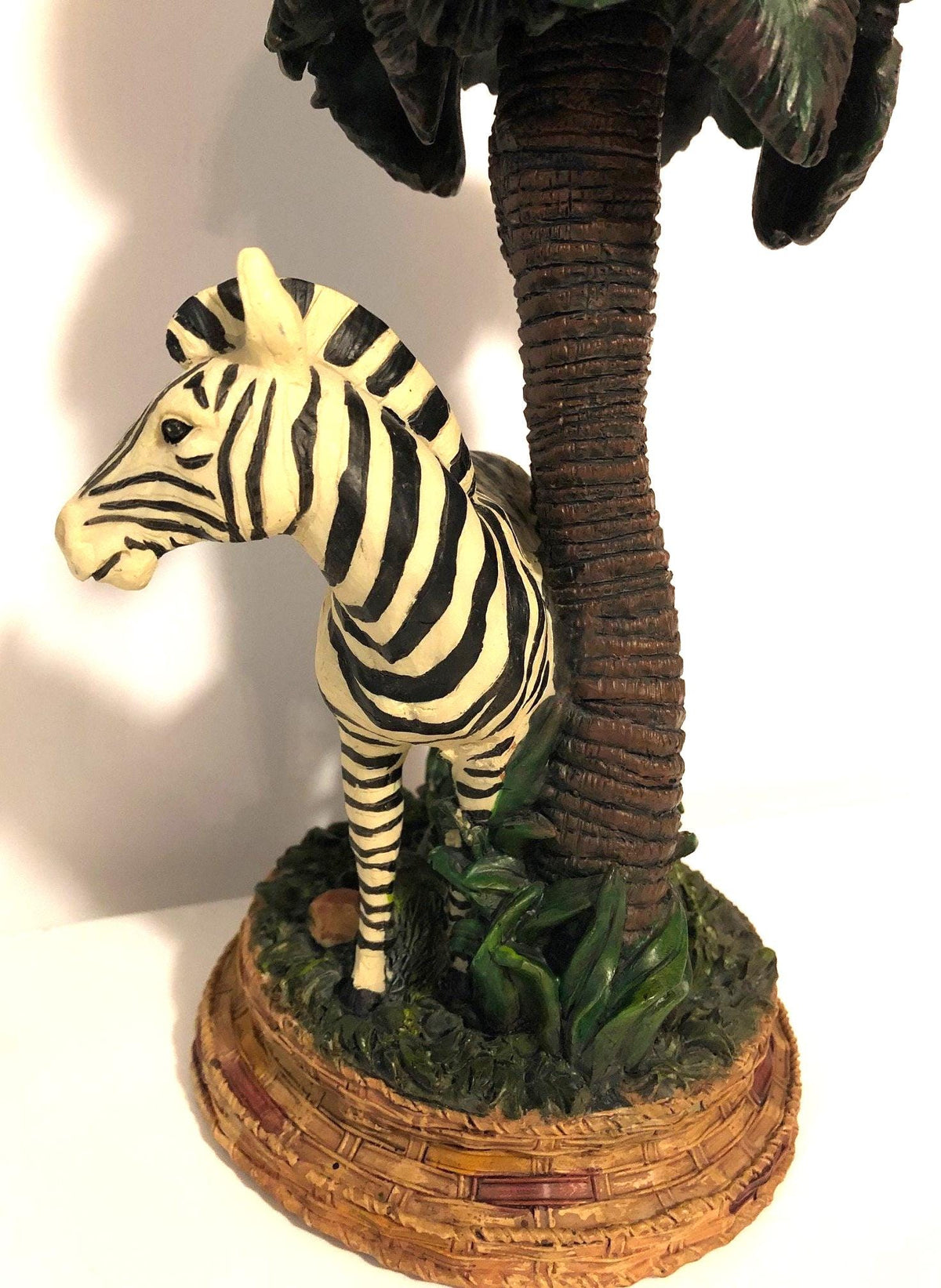 Zebra Clock Sculptured in the Grass with Palm Trees.  5" x 6" x 15" high. Clock works with AA battery, not included.  Excellent Condition