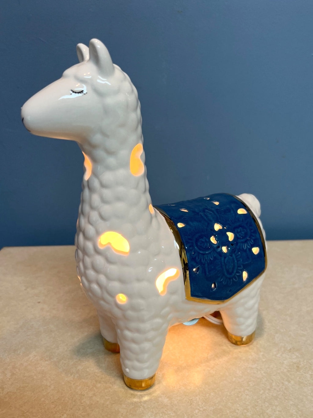 Ceramic Llama-Shaped Electric Accent Night Light With Gold Accents & Blue Saddle Design Illuminated Cutouts 9.5" tall