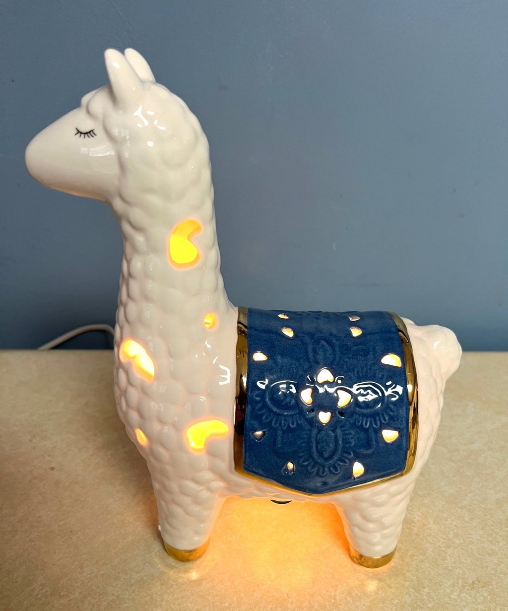 Ceramic Llama-Shaped Electric Accent Night Light With Gold Accents & Blue Saddle Design Illuminated Cutouts 9.5" tall