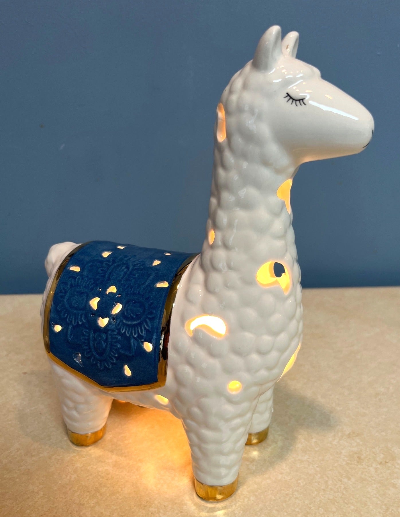 Ceramic Llama-Shaped Electric Accent Night Light With Gold Accents & Blue Saddle Design Illuminated Cutouts 9.5" tall