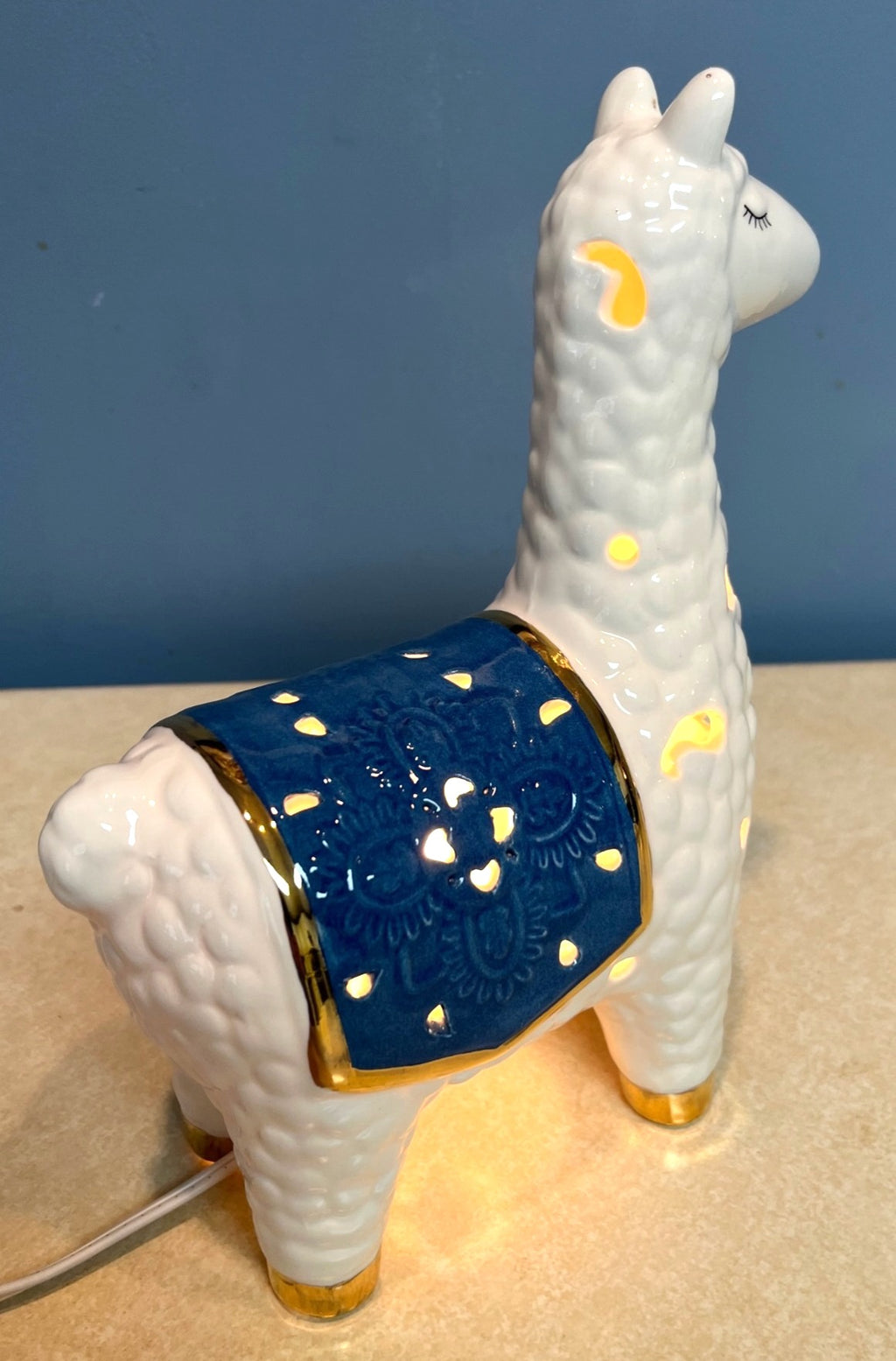 Ceramic Llama-Shaped Electric Accent Night Light With Gold Accents & Blue Saddle Design Illuminated Cutouts 9.5" tall