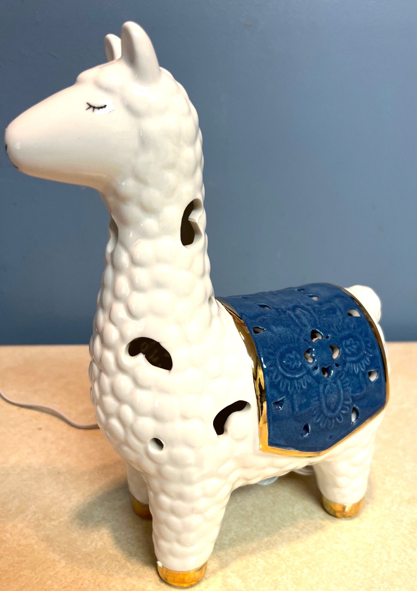 Ceramic Llama-Shaped Electric Accent Night Light With Gold Accents & Blue Saddle Design Illuminated Cutouts 9.5" tall