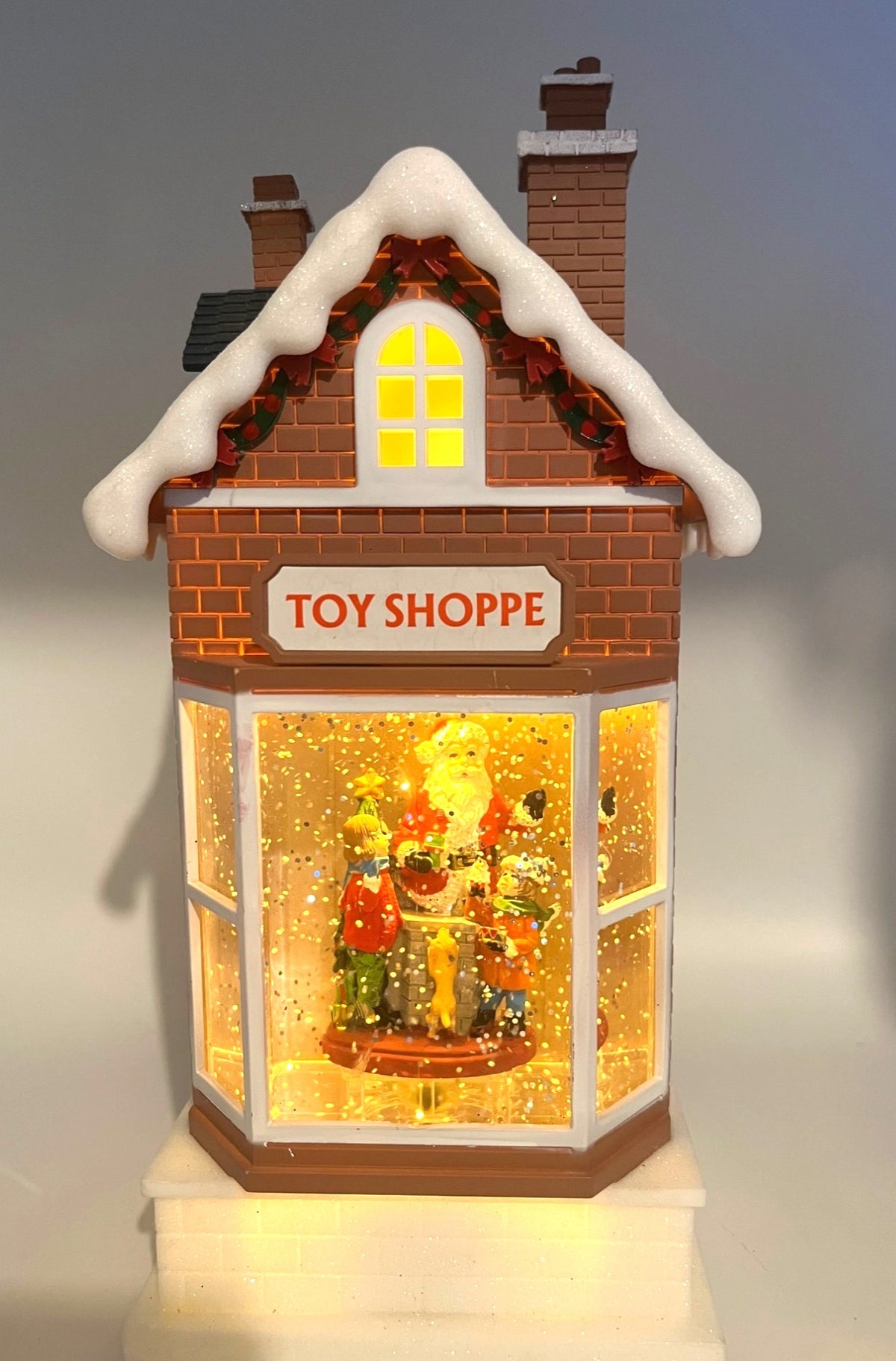Light-Up Musical Christmas Toy Shoppe Snow Globe Decoration With Santa Scene 11" tall